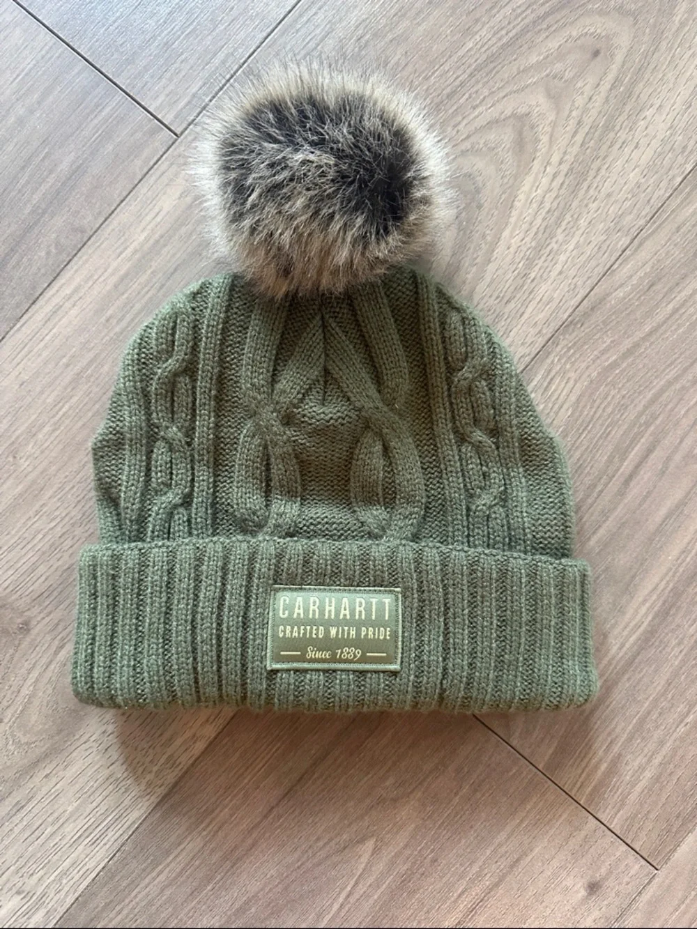 Carhartt beanie hat with faux fur Pom Pom . Like new!